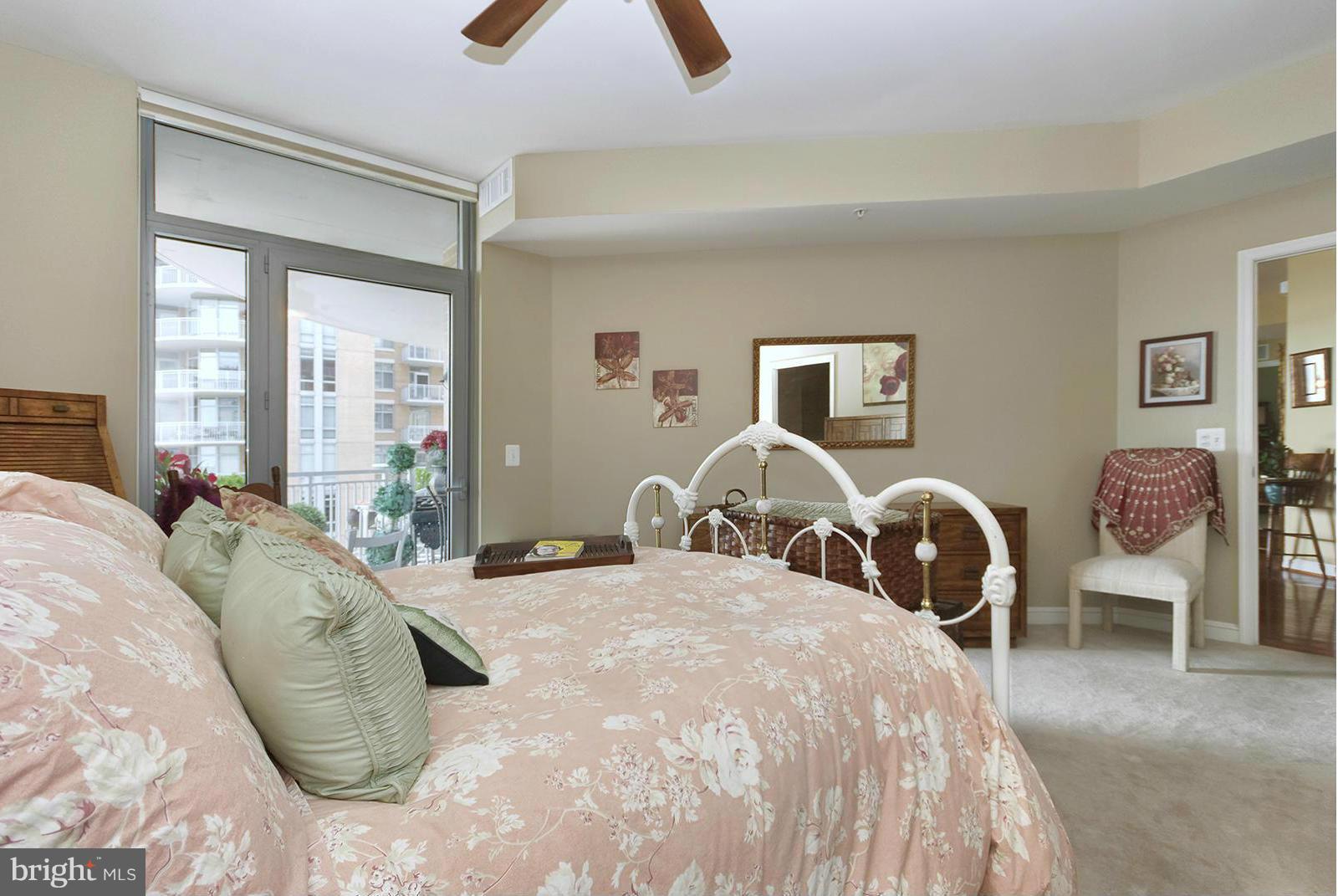 11990 Market Street, Unit 801 Reston, VA 20190 - Photo 11 of 25 a bed room with two bed and a large mirror