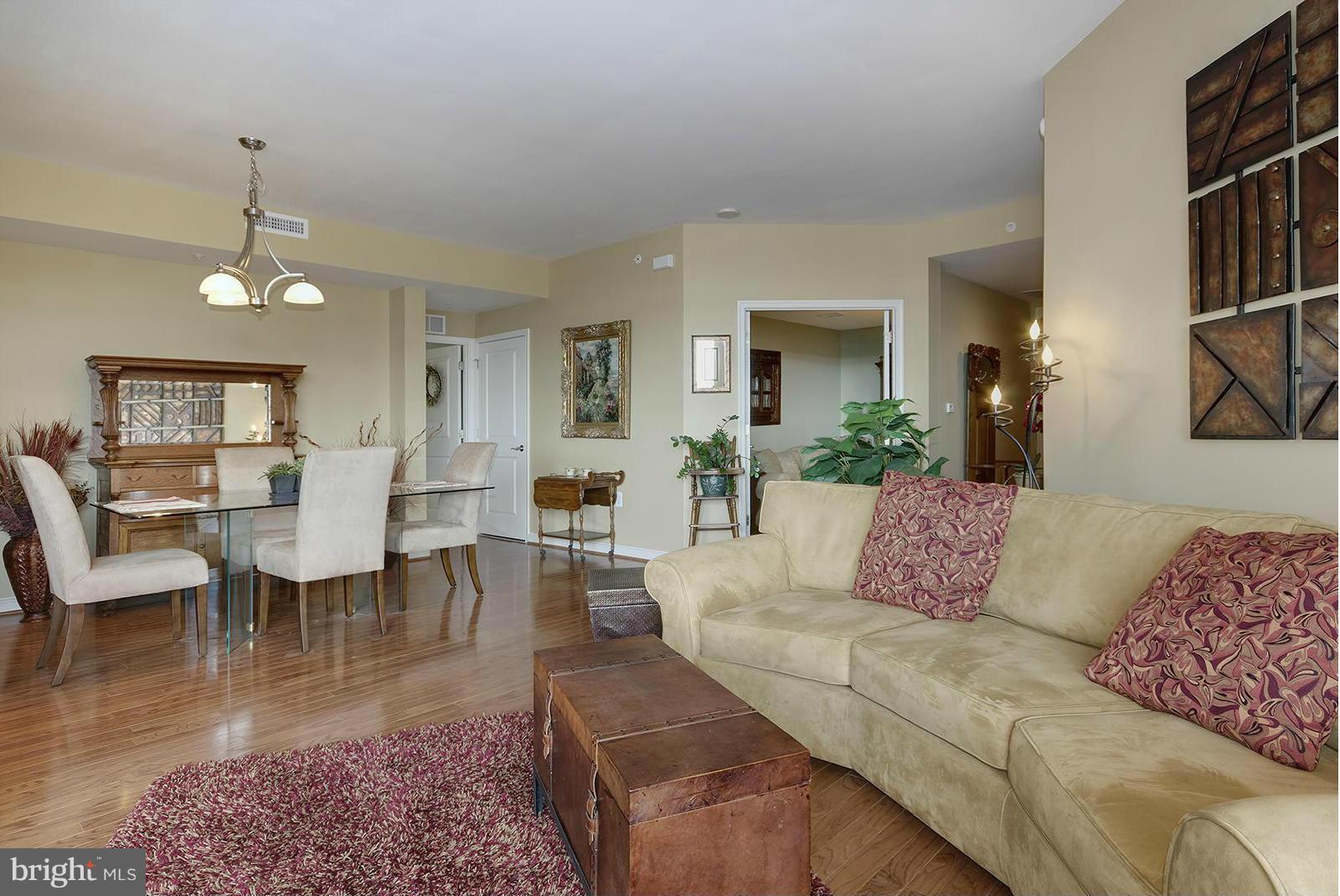 11990 Market Street, Unit 801 Reston, VA 20190 - Photo 3 of 25 a living room with furniture wooden floor and a chandelier