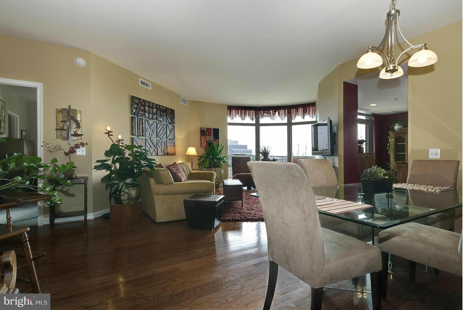 11990 Market Street, Unit 801 Reston, VA 20190 - Photo 4 of 25 a view of a dining room with furniture window and wooden floor