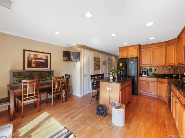 a living room with dining room and wooden floor