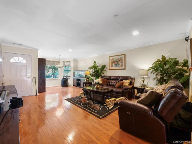a living room with furniture window and wooden floor