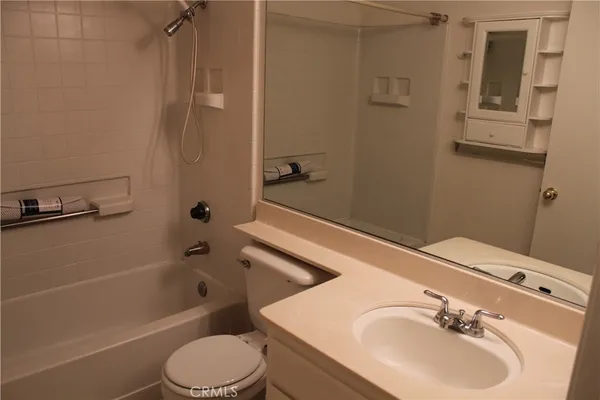a bathroom with a shower a toilet and a sink