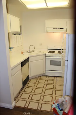 a kitchen with a stove and a refrigerator
