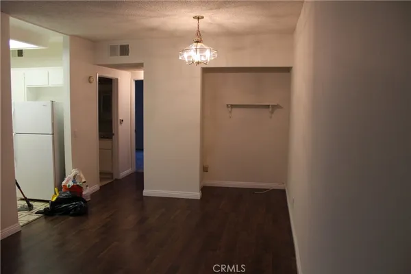 a view of a room with wooden floor and a window