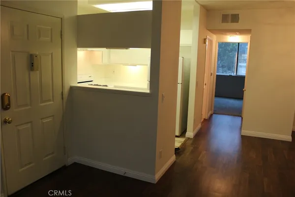 a view of a room with wooden floor and a window