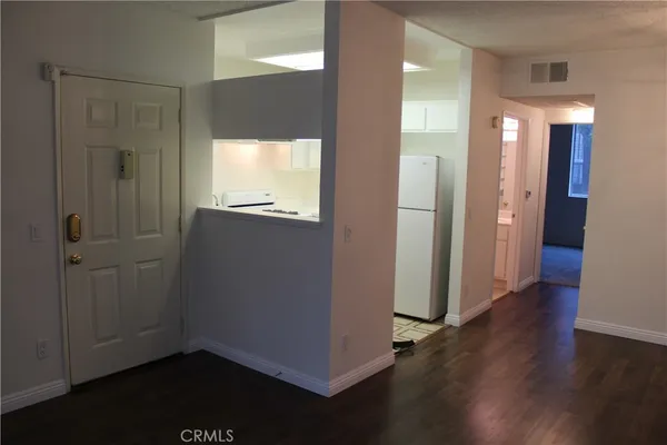 a view of a hallway with wooden floor