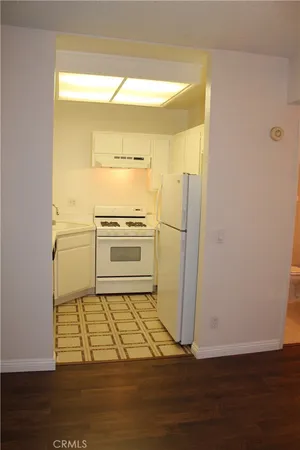 a kitchen with a refrigerator and a stove