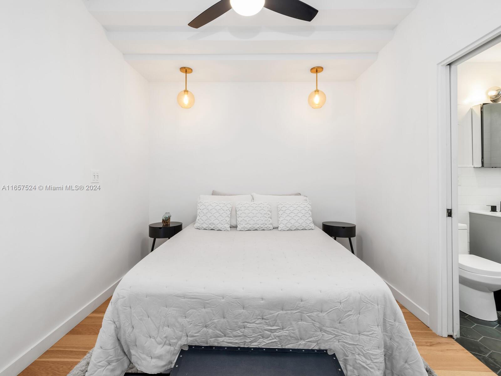 742 12th Street, Unit 2 Miami Beach, FL 33139 - Photo 11 of 27 a bedroom with a bed and cabinets