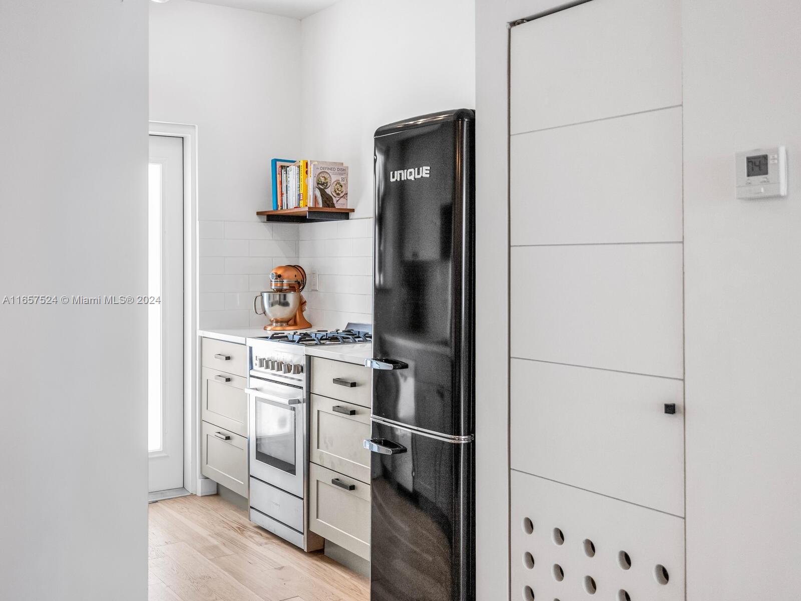 742 12th Street, Unit 2 Miami Beach, FL 33139 - Photo 14 of 27 a kitchen with stainless steel appliances a refrigerator and cabinets