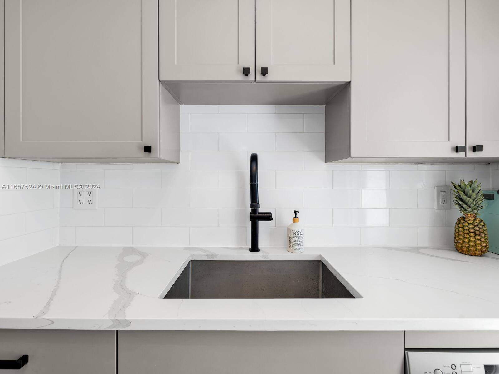 742 12th Street, Unit 2 Miami Beach, FL 33139 - Photo 15 of 27 a kitchen with a sink and cabinets