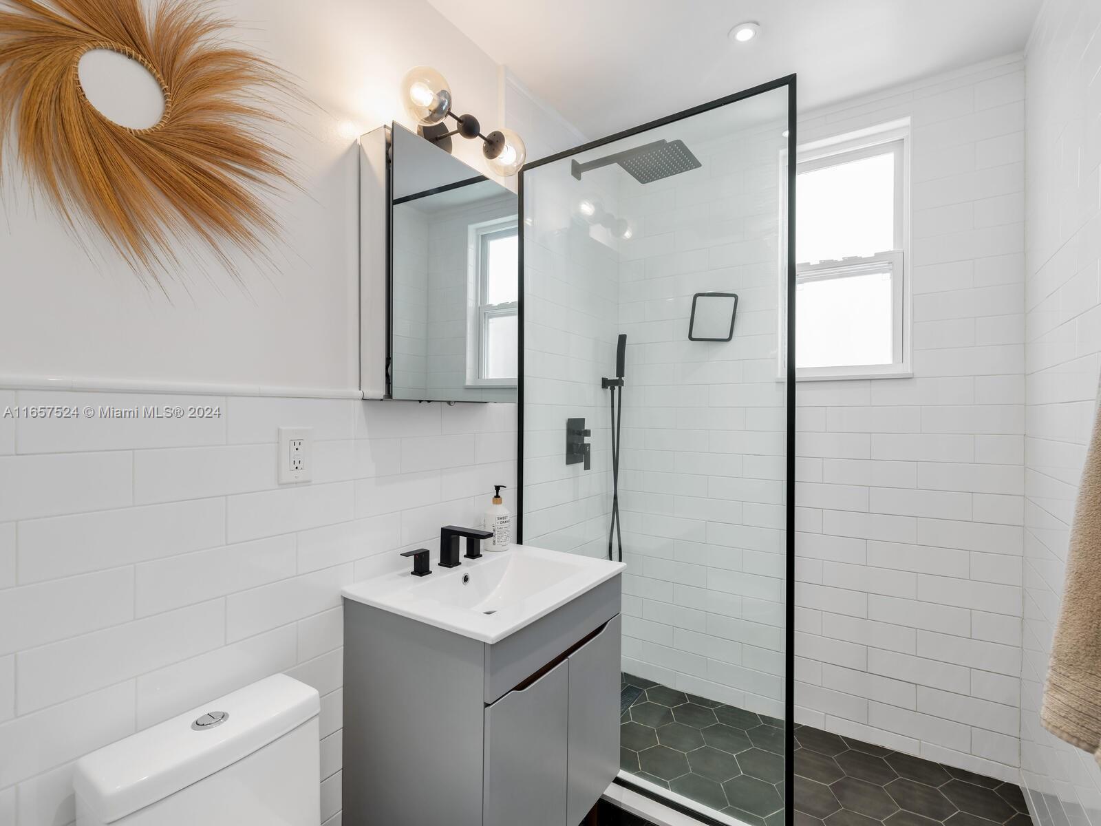742 12th Street, Unit 2 Miami Beach, FL 33139 - Photo 18 of 27 a bathroom with a sink a toilet and shower