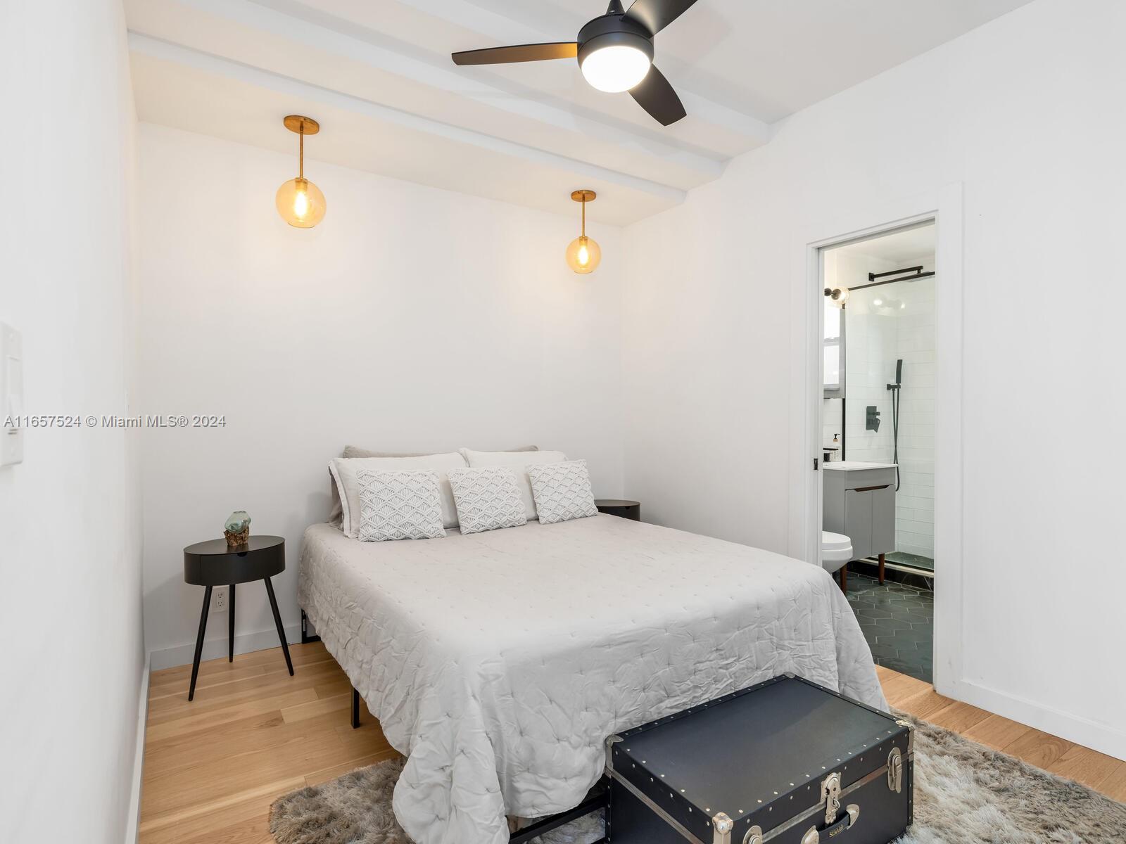 742 12th Street, Unit 2 Miami Beach, FL 33139 - Photo 10 of 27 a bedroom with a bed and a chandelier