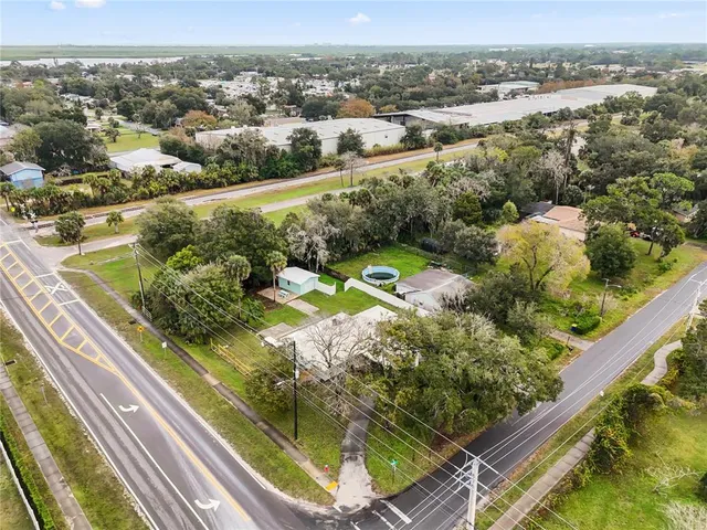 an aerial view of a house with a yard