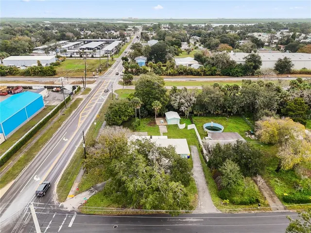 an aerial view of residential houses with outdoor space and swimming pool