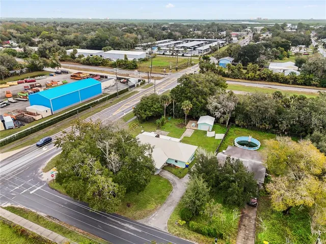 a view of a house with a backyard space and sitting area