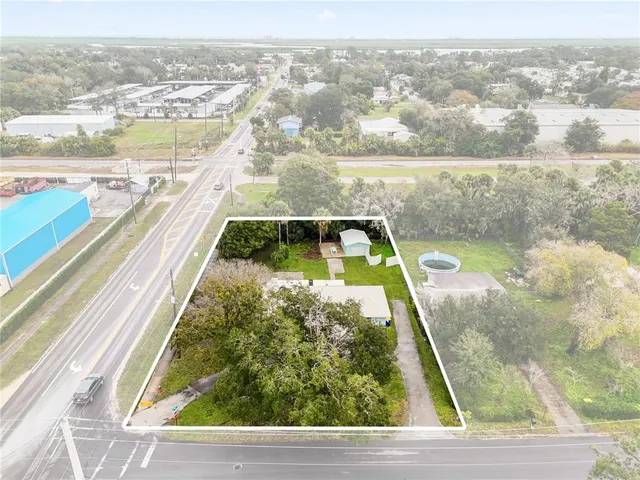 an aerial view of a resort with swimming pool and outdoor seating