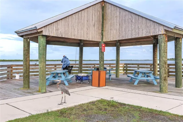 wooden roof deck with table and chairs under an umbrella