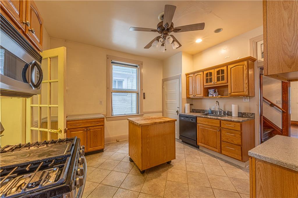 114 Union Street Uniontown, PA 15401 - Photo 7 of 28 a kitchen with stainless steel appliances granite countertop a stove and a refrigerator