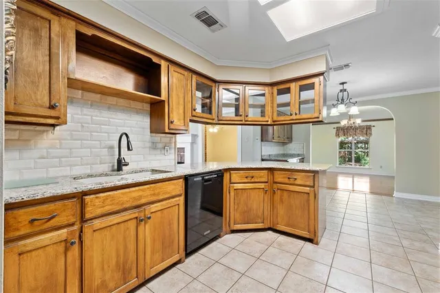 a kitchen with stainless steel appliances granite countertop a sink and cabinets