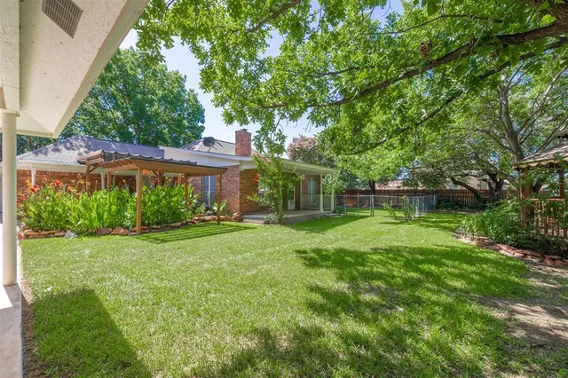 a view of a house with backyard and a sitting area