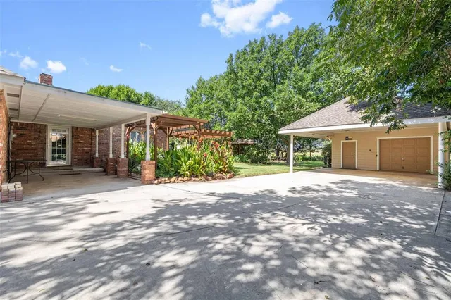 a view of a house with a yard and potted plants