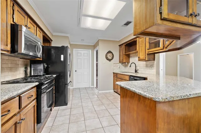 a kitchen with stainless steel appliances granite countertop a stove and a sink