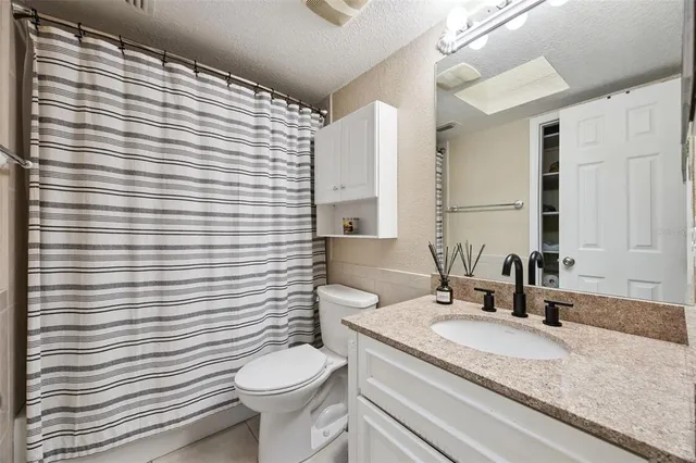 a view of empty room with wooden floor and windows