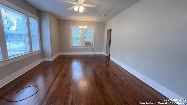 wooden floor in an empty room with a window