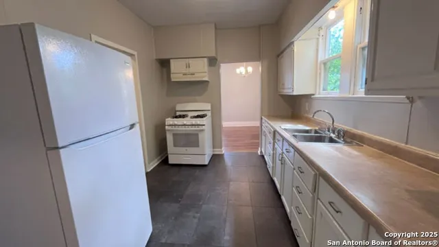 a kitchen with stainless steel appliances a sink stove and refrigerator