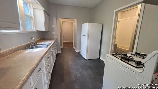 a kitchen with a refrigerator and a sink