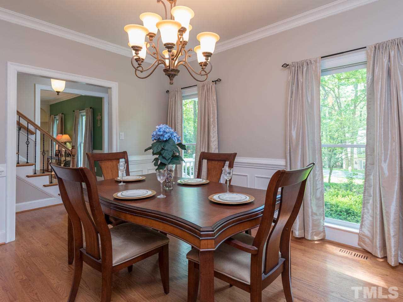 1401 October Road Raleigh, NC 27614 - Photo 3 of 30 a view of a dining room with furniture a chandelier and wooden floor