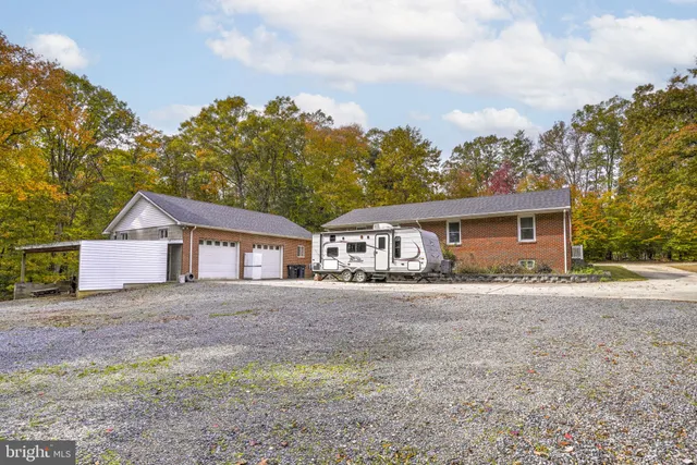 a backyard of a house with barbeque oven table and chairs
