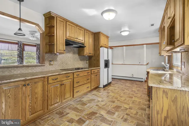 a kitchen with a stove and a refrigerator