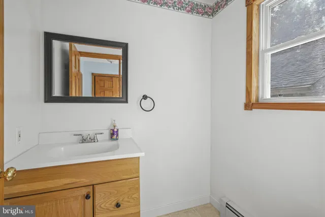 a view of empty room with wooden floor and windows