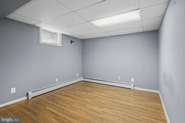 a bedroom with bed and wooden floor