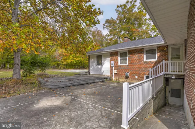 a view of a yard with swimming pool and trees
