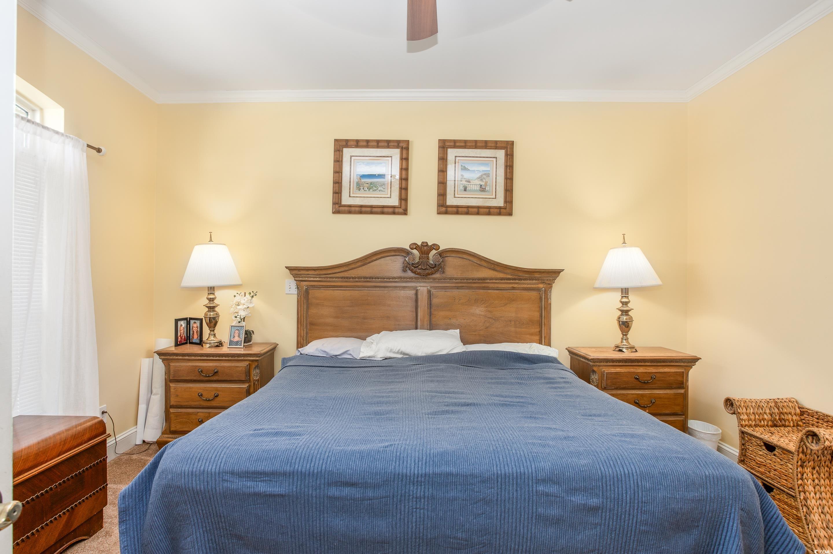 4907 Woodview Lane Myrtle Beach, SC 29575 - Photo 13 of 30 Bedroom with crown molding, carpet flooring, and ceiling fan