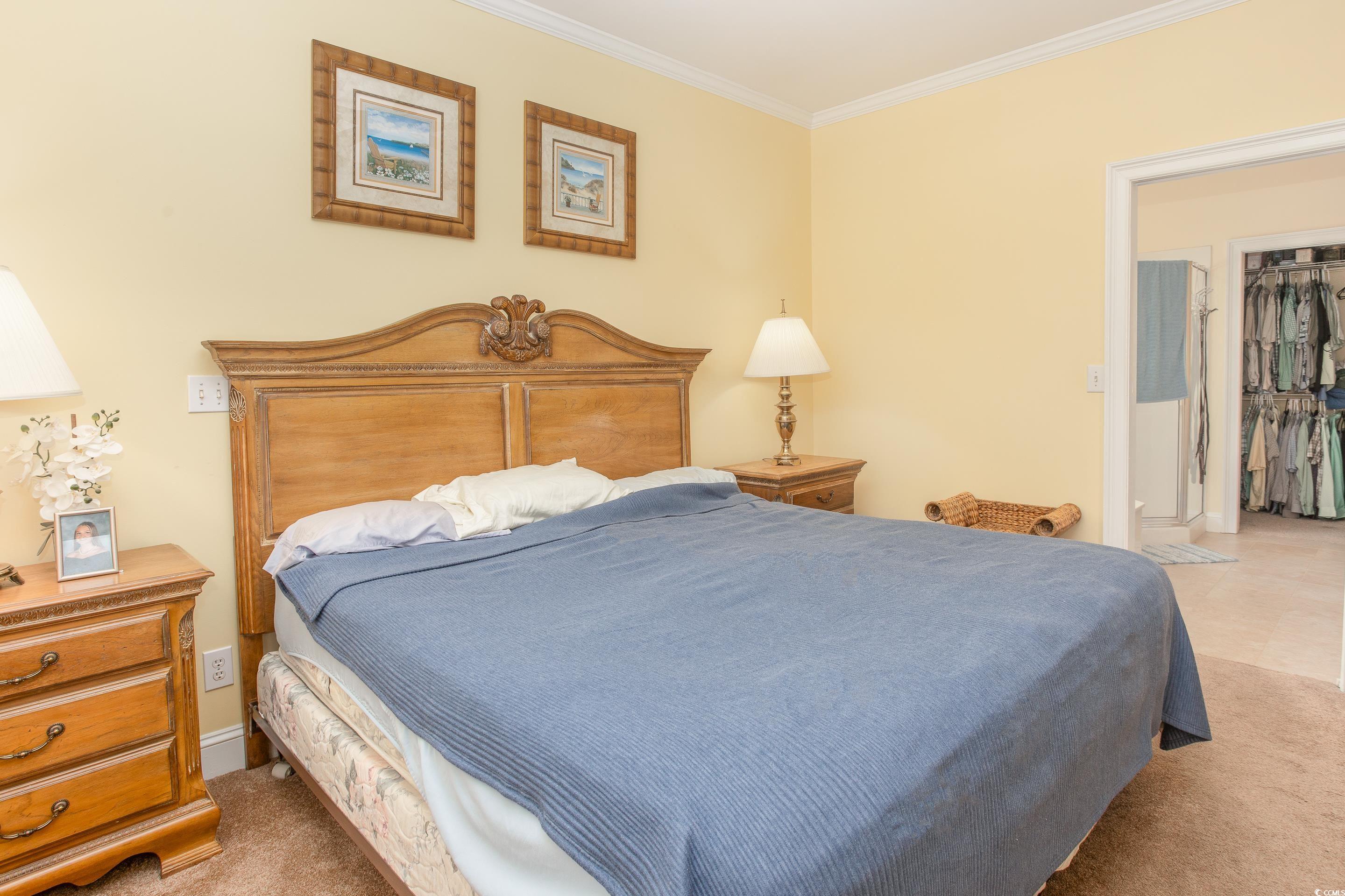 4907 Woodview Lane Myrtle Beach, SC 29575 - Photo 14 of 30 Carpeted bedroom featuring crown molding and baseboards