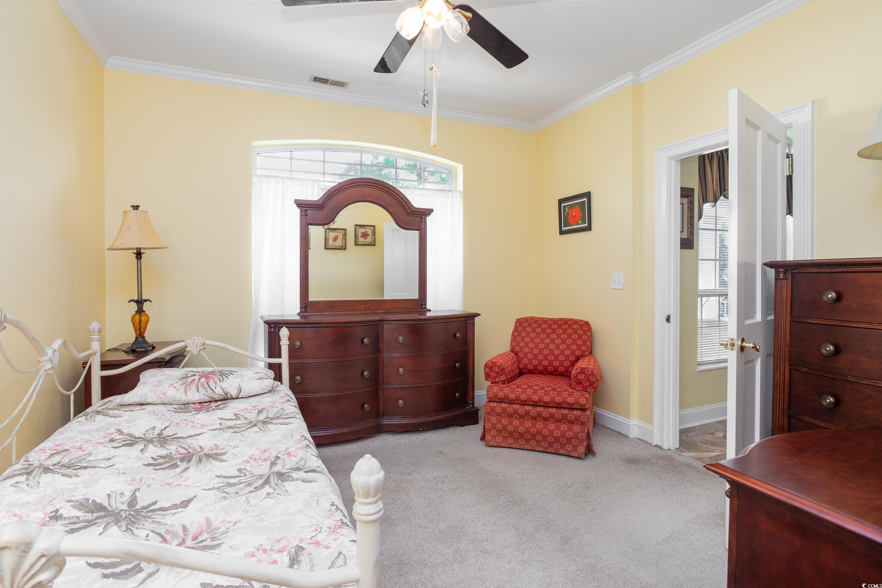4907 Woodview Lane Myrtle Beach, SC 29575 - Photo 17 of 30 Bedroom featuring carpet flooring, ornamental molding, and a ceiling fan