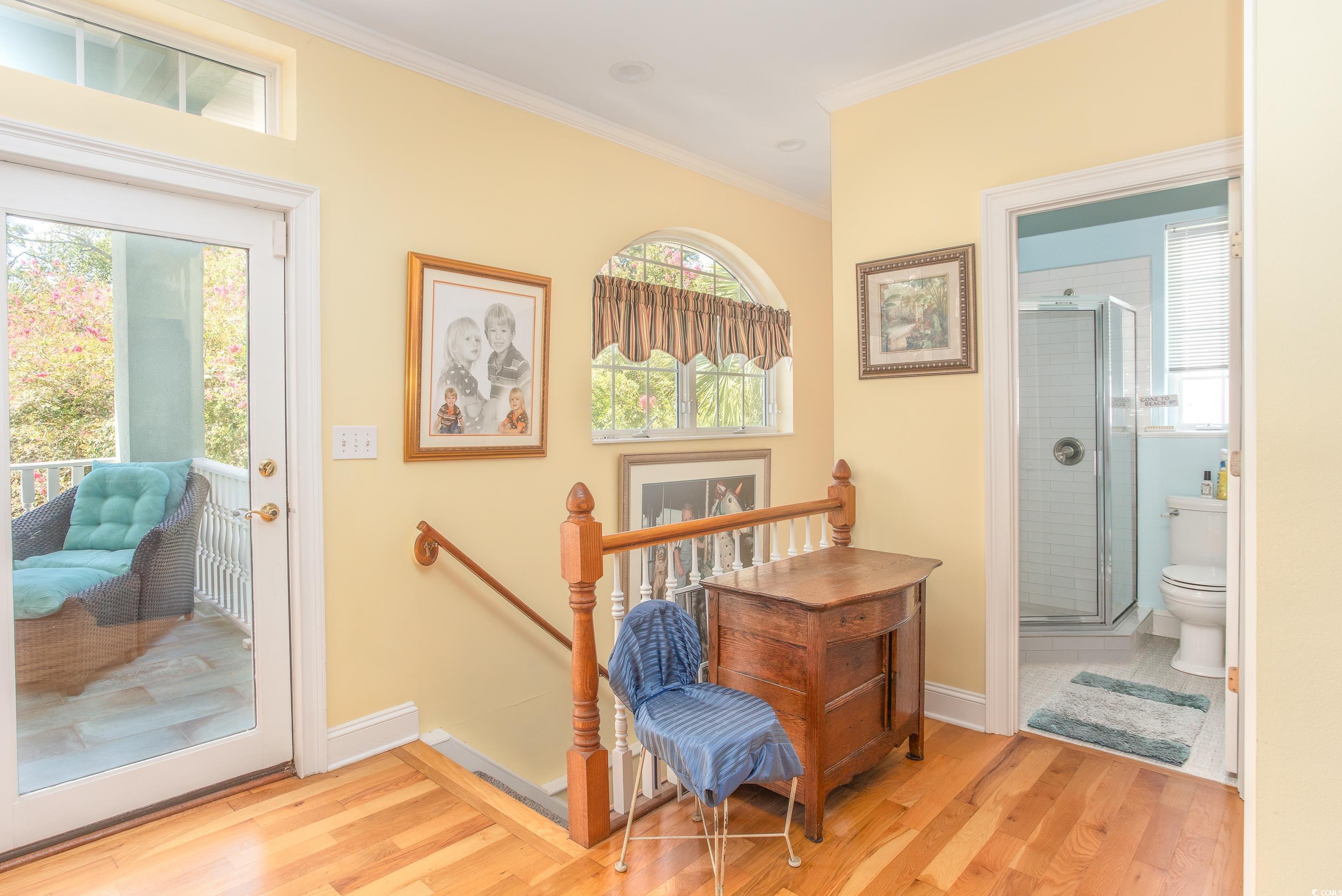 4907 Woodview Lane Myrtle Beach, SC 29575 - Photo 20 of 30 Sitting room with ornamental molding, light wood-type flooring, and an upstairs landing