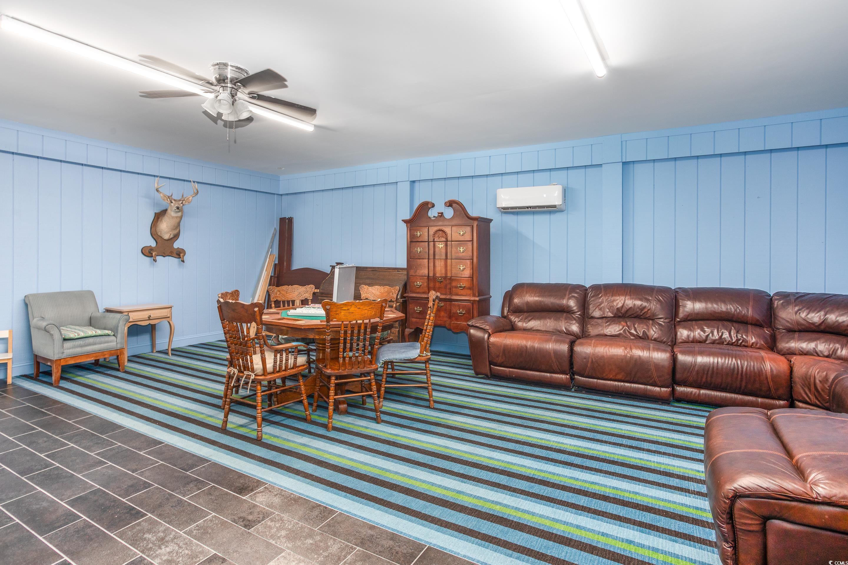 4907 Woodview Lane Myrtle Beach, SC 29575 - Photo 21 of 30 Living area featuring a ceiling fan and a wall mounted AC