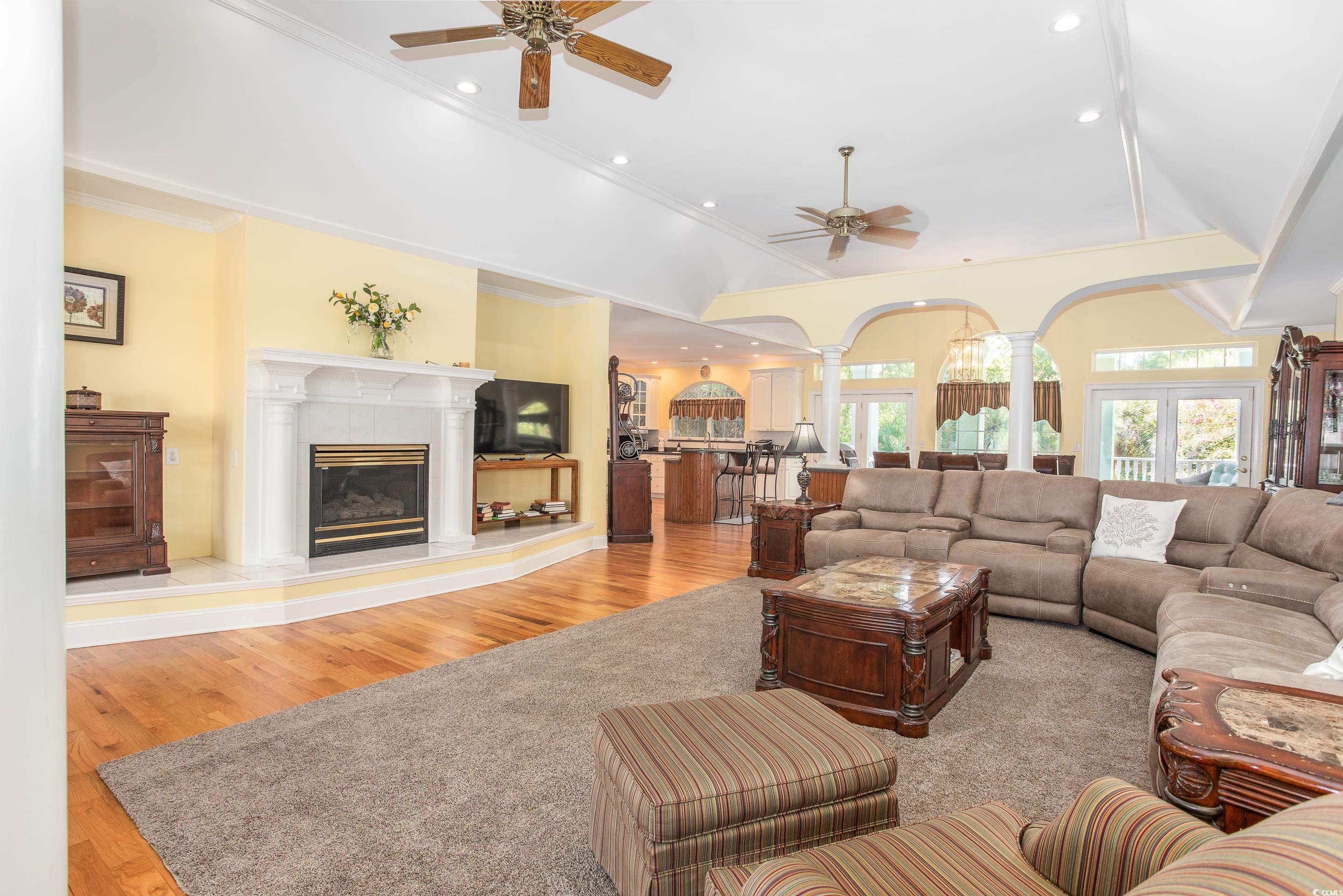 4907 Woodview Lane Myrtle Beach, SC 29575 - Photo 8 of 30 Living area with decorative columns, ceiling fan, wood finished floors, recessed lighting, and crown molding