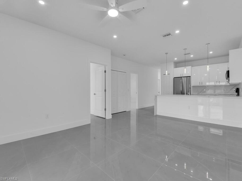2212-2214 Wilson Road Lehigh Acres, FL 33973 - Photo 12 of 49 a view of a kitchen with a sink and a refrigerator