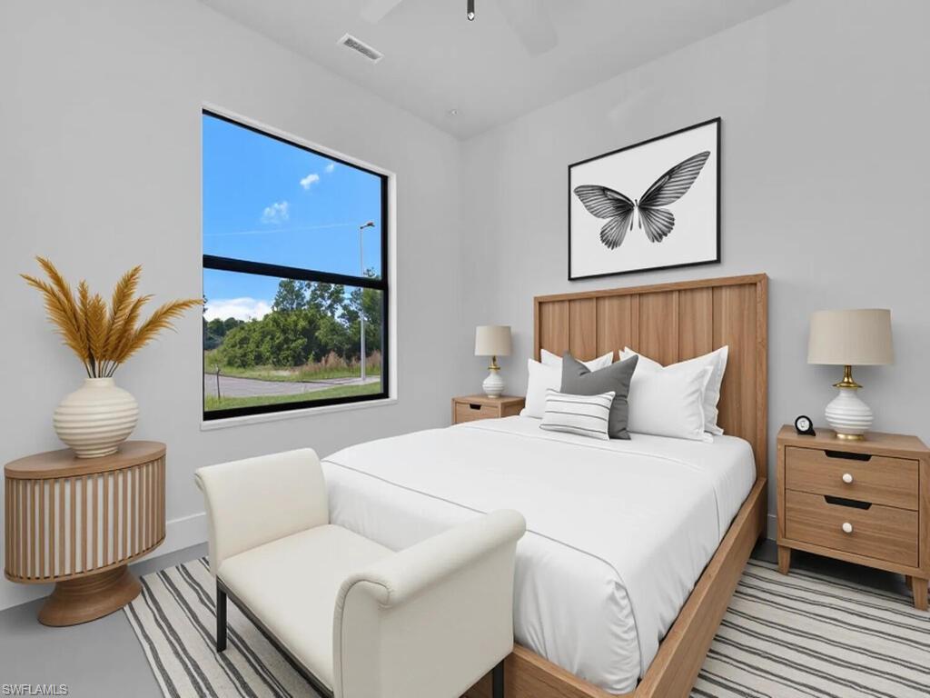 2212-2214 Wilson Road Lehigh Acres, FL 33973 - Photo 18 of 49 a bedroom with a bed and a painting on the wall