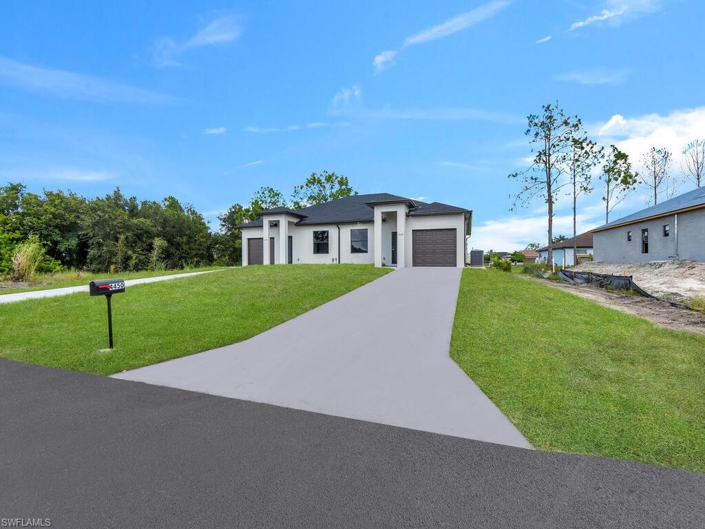 2212-2214 Wilson Road Lehigh Acres, FL 33973 - Photo 2 of 49 a view of a house with a big yard