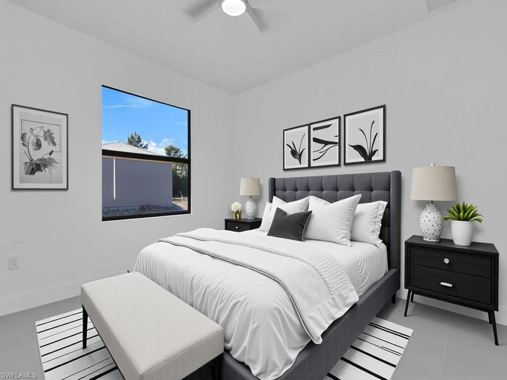 2212-2214 Wilson Road Lehigh Acres, FL 33973 - Photo 22 of 49 a bedroom with a bed and a lamp on dresser