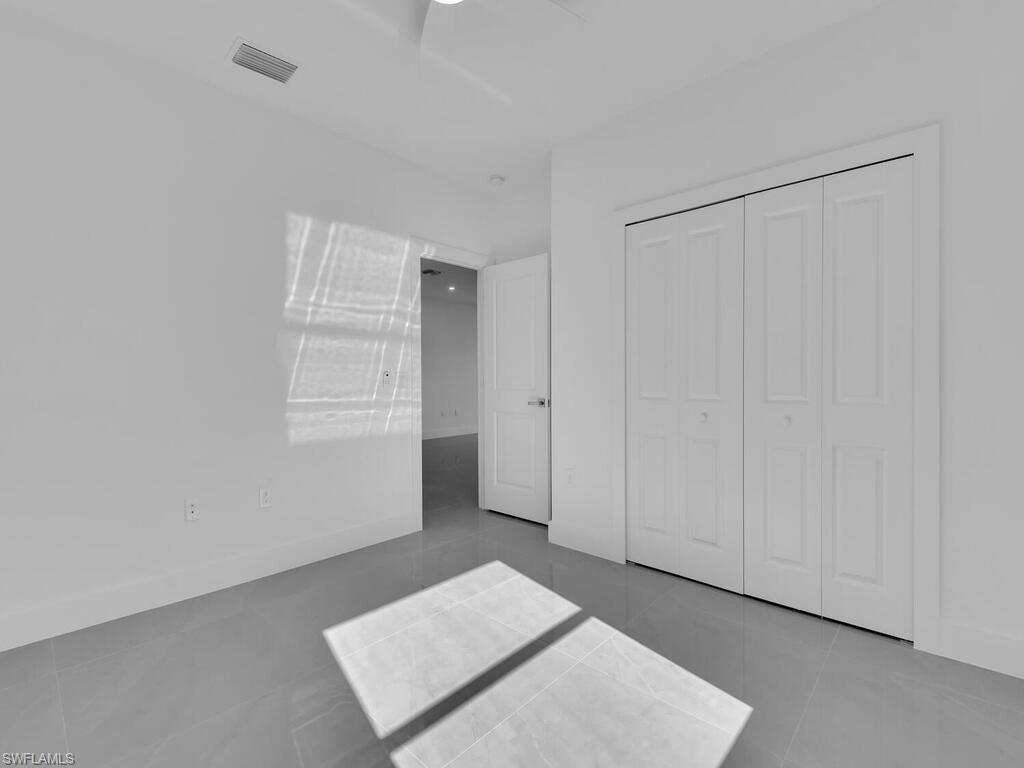 2212-2214 Wilson Road Lehigh Acres, FL 33973 - Photo 24 of 49 a view of an empty room with windows