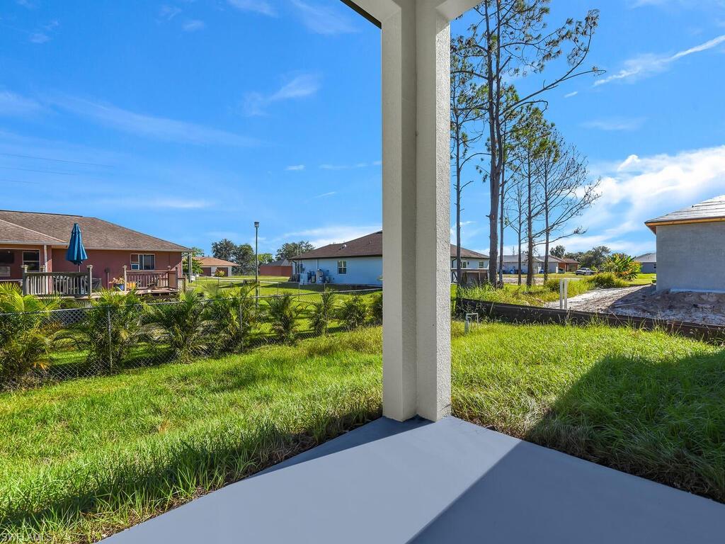 2212-2214 Wilson Road Lehigh Acres, FL 33973 - Photo 25 of 49 a view of a garden with a building in the background