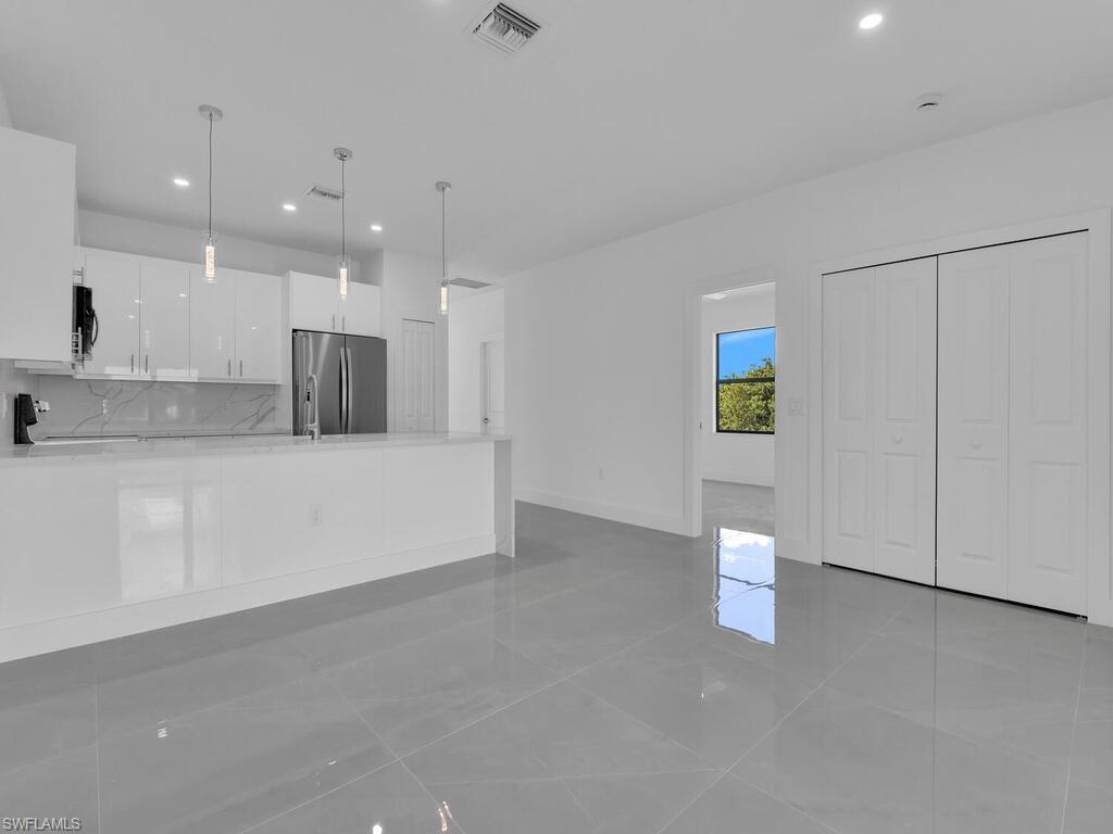 2212-2214 Wilson Road Lehigh Acres, FL 33973 - Photo 34 of 49 a view of a kitchen with a sink and a refrigerator