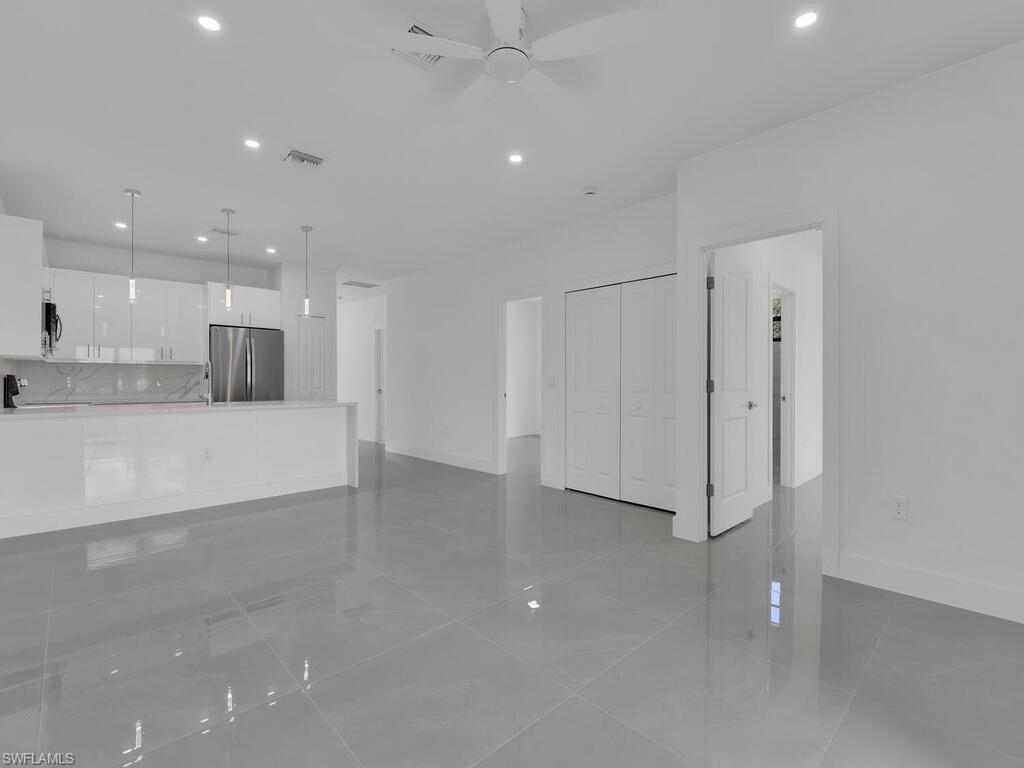2212-2214 Wilson Road Lehigh Acres, FL 33973 - Photo 37 of 49 a view of a kitchen with a refrigerator and a stove top oven
